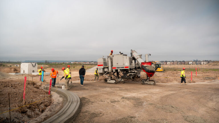 angled curb being laid by construction team