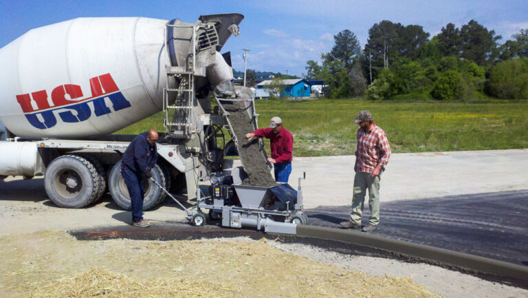 construction team using extruder to lay curb