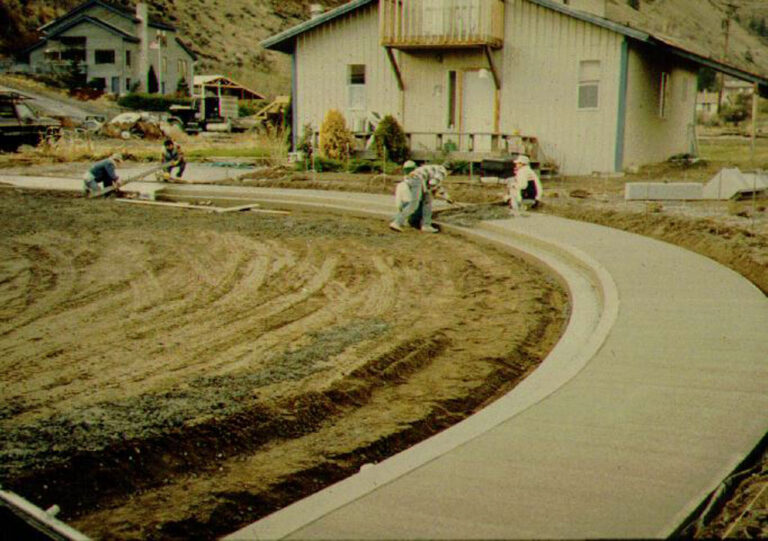 construction workers laying sidewalk