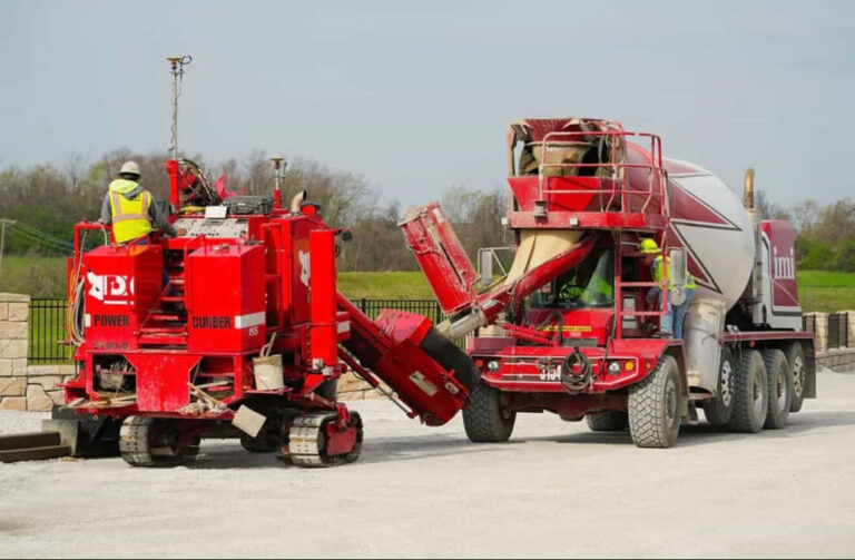 crew operating red Power Curbers machines as they lay curb